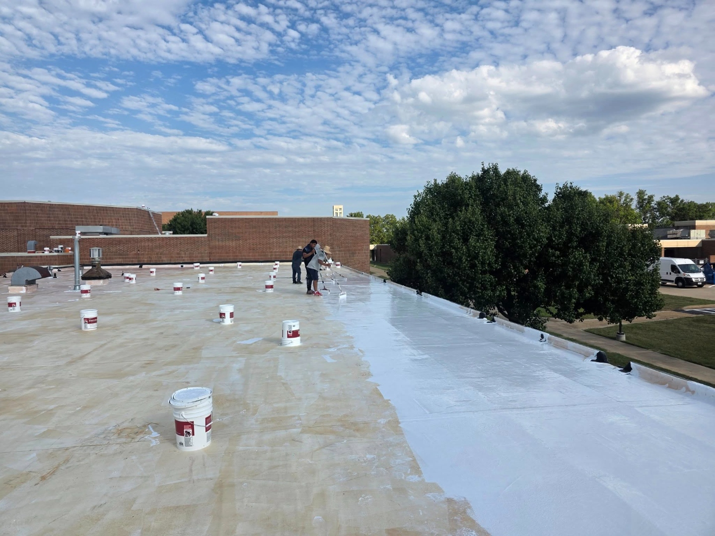 Blue Ox crew applying Gaco silicone coating on a commercial roof in Central Missouri